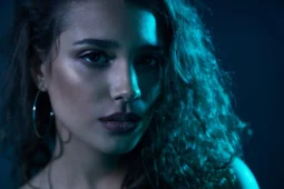 woman posing under neon lights